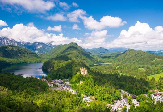 Castle-Hohenschwangau-eternal-forest-with-blue-mountains-and-lakes-of-Bavaria-Germany