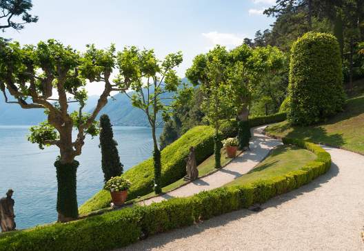 Tranquil-winding-path-in-the-Villa-Balbianello-garden-along-the-shore-of-lake-Como-Italy