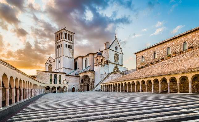 Famous-Basilica-of-St.-Francis-of-Assisi-Basilica-Papale-di-San-Francesco-with-Lower-Plaza-at-sunset-in-Assisi-Umbria-Italy