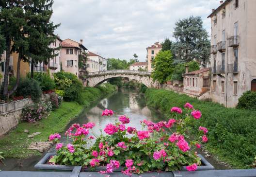 Flowered-iron-balcony-of-Saint-Paul-bridge-in-Vicenza-with-a-view-of-Retrone-river-and-Saint-Michele-bridge-in-the-background