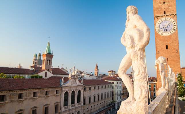 Statues-on-the-top-of-the-Basilica-palladiana-in-Vicenza-the-clock-tower-and-a-view-of-Lords-Square