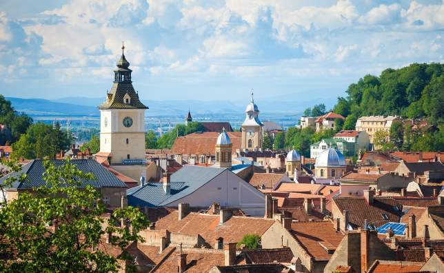 Old Brasov city buildings roof and The Council House clock tower