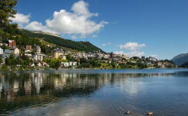 Cityscape of Saint Moritz with lake blue sky and clouds Engadin Switzerland Europe