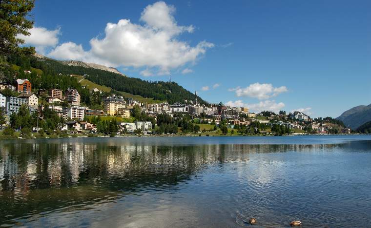 Cityscape of Saint Moritz with lake blue sky and clouds Engadin Switzerland Europe