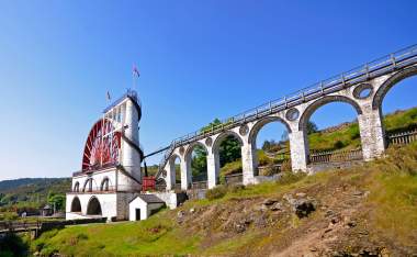 The Great Laxey Wheel with viaduct on sunny day Isle of Man