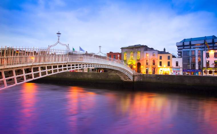 Dublin Ireland at dusk with waterfront and historic Hapenny Bridge
